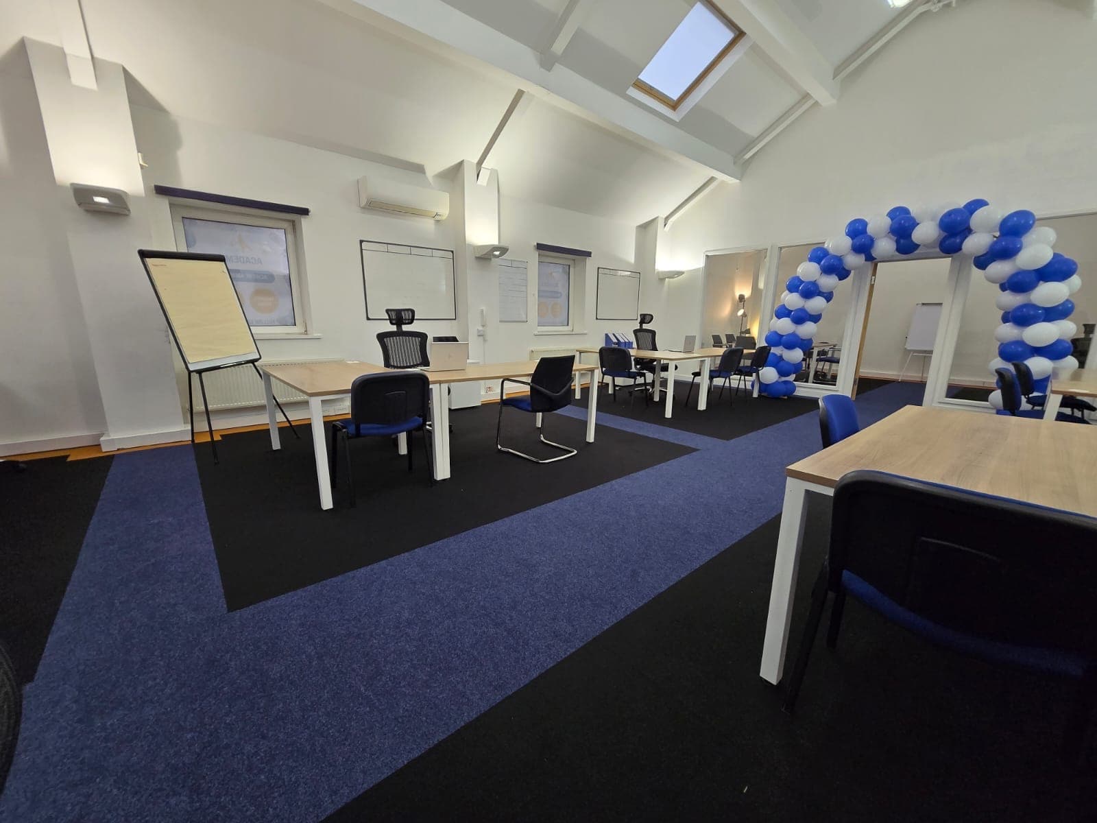 Open-plan study area with desks and a flipchart at the Cheadle centre