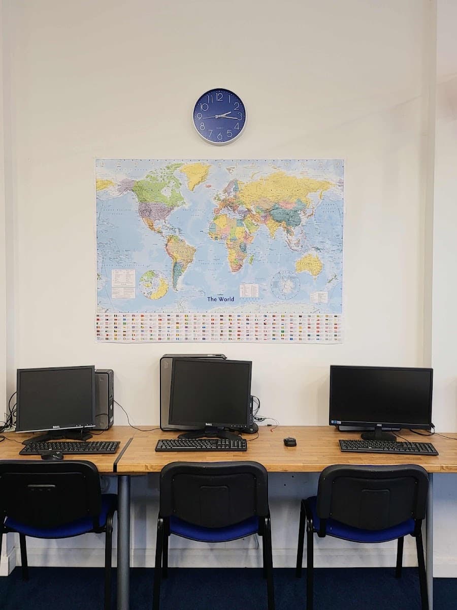 Computer stations beneath a world map at the Longsight centre
